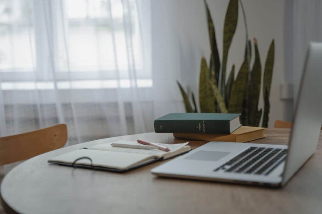SEO Implementation 1 laptop on a desk with books